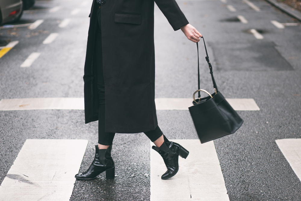 Style and fashion concept with urban city backdrop and all black outfit