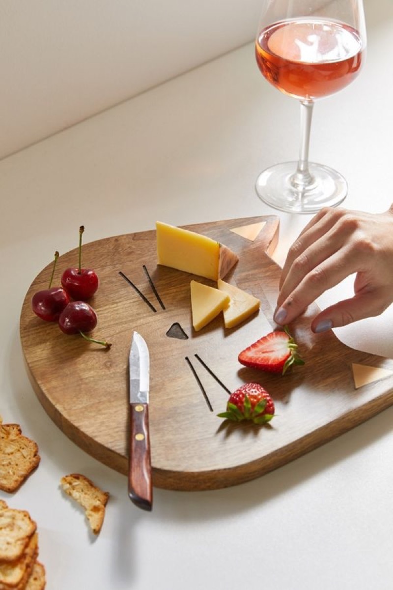 wooden cutting board with cat whiskers carved into it