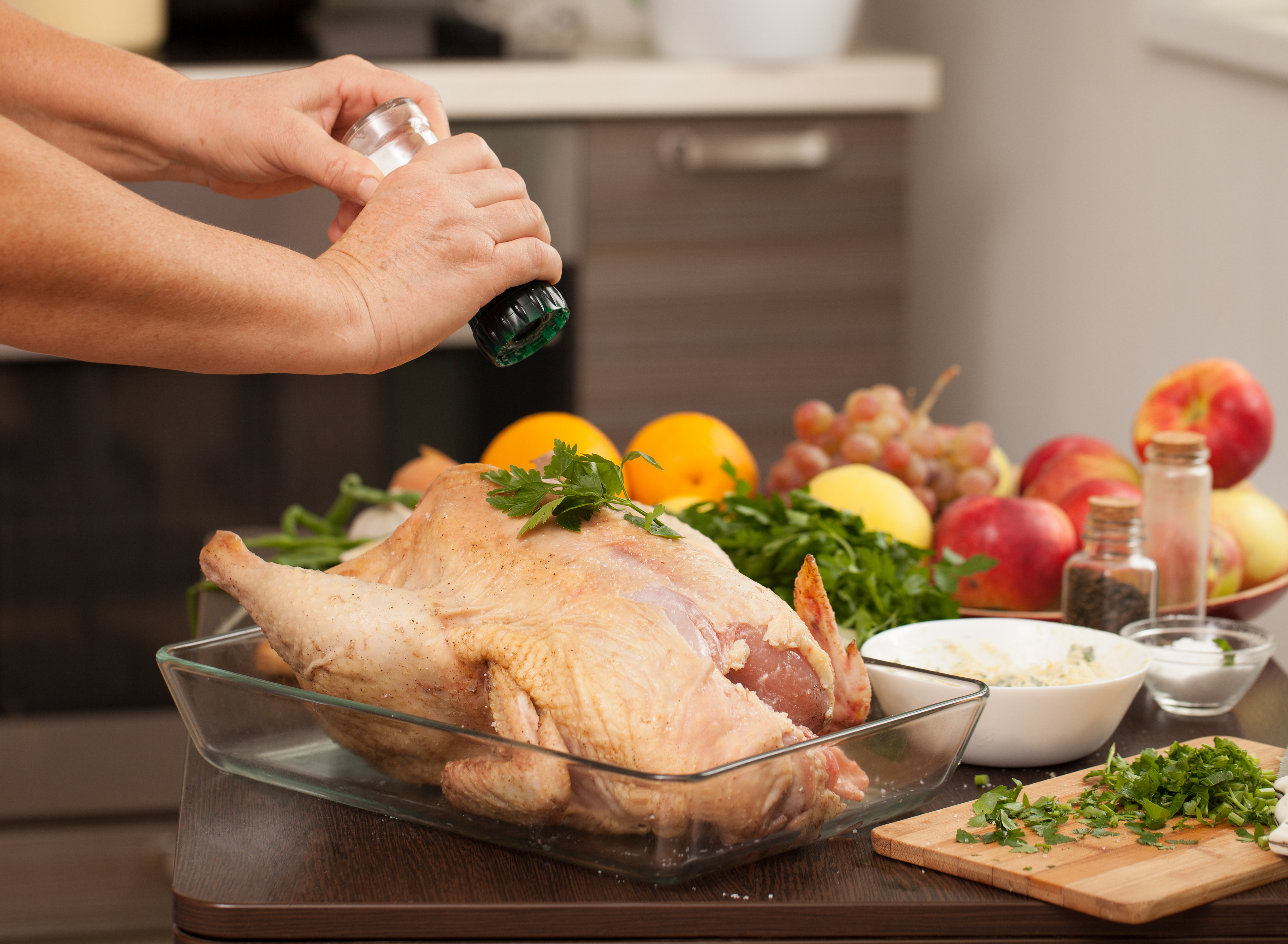 Thanksgiving turkey being seasoned.