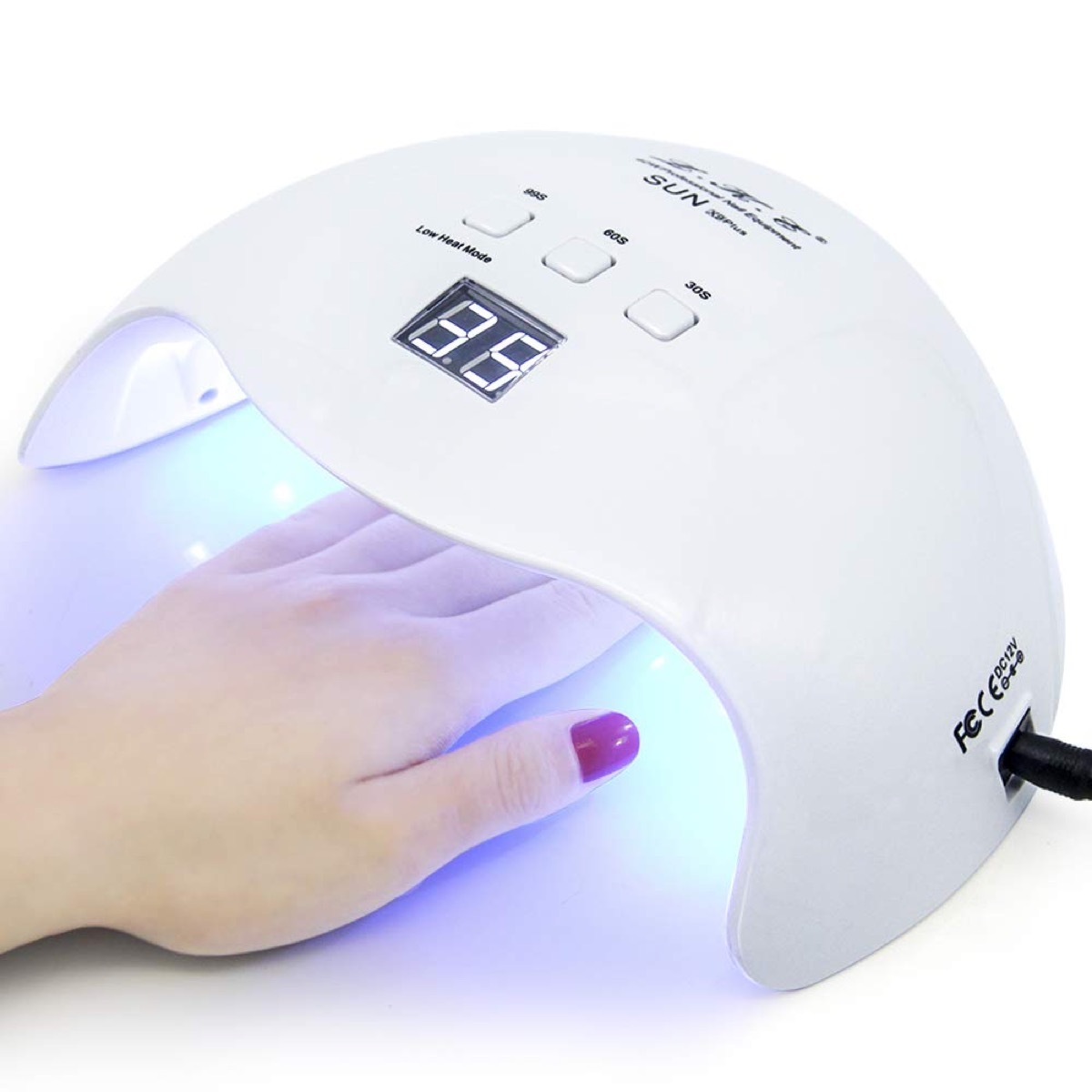 Hand in gel nail dryer