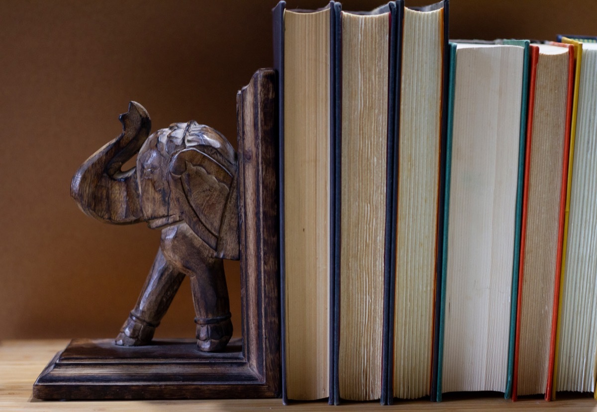 elephant bookend next to a stack of books