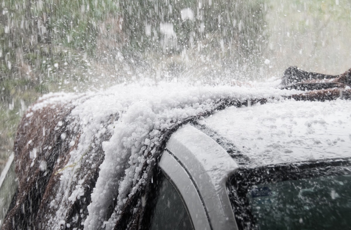 Large hail stones pelting car roof during storm