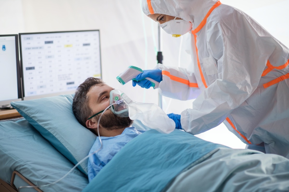 Infected patient in quarantine lying in bed in hospital.