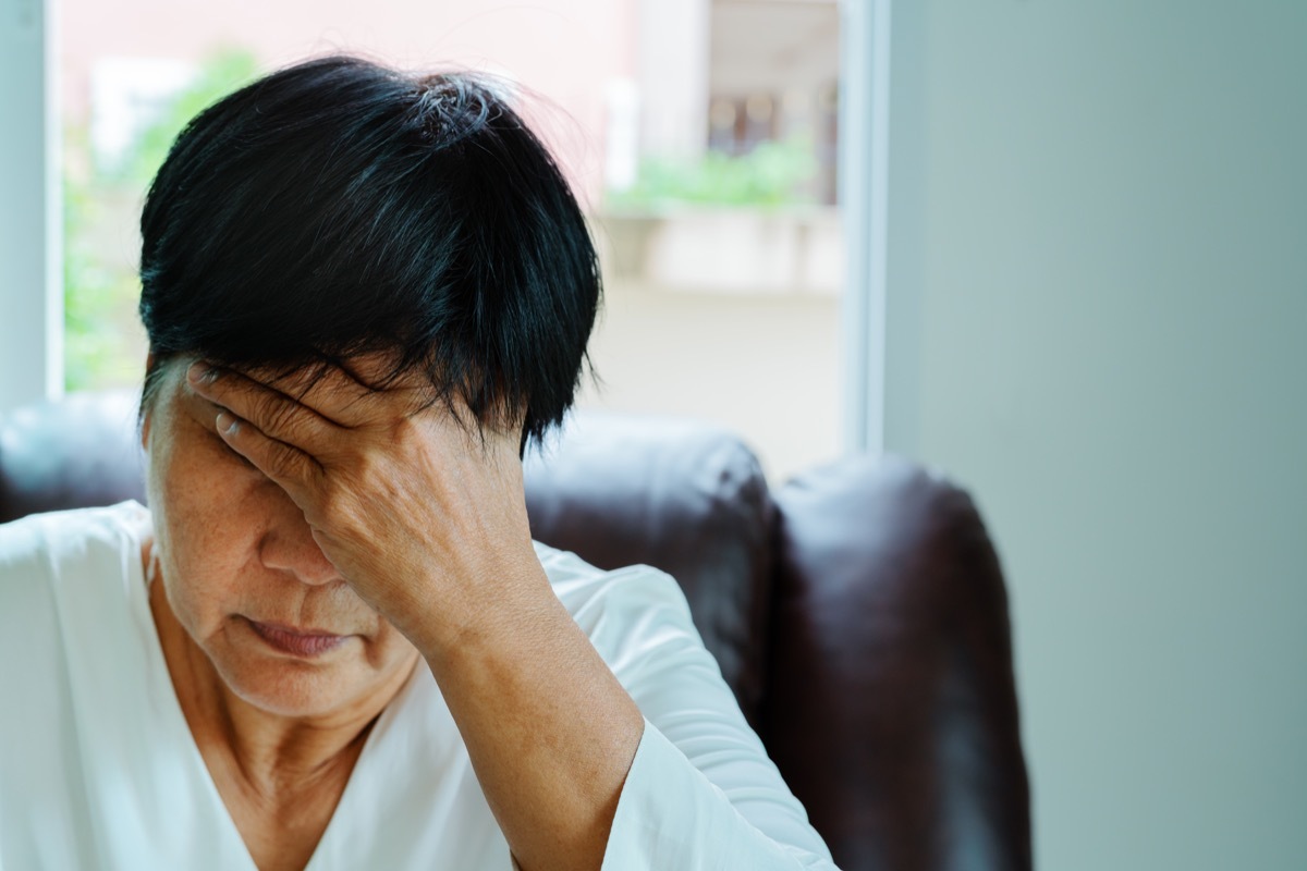 stressed woman sitting in a chair, health questions after 50