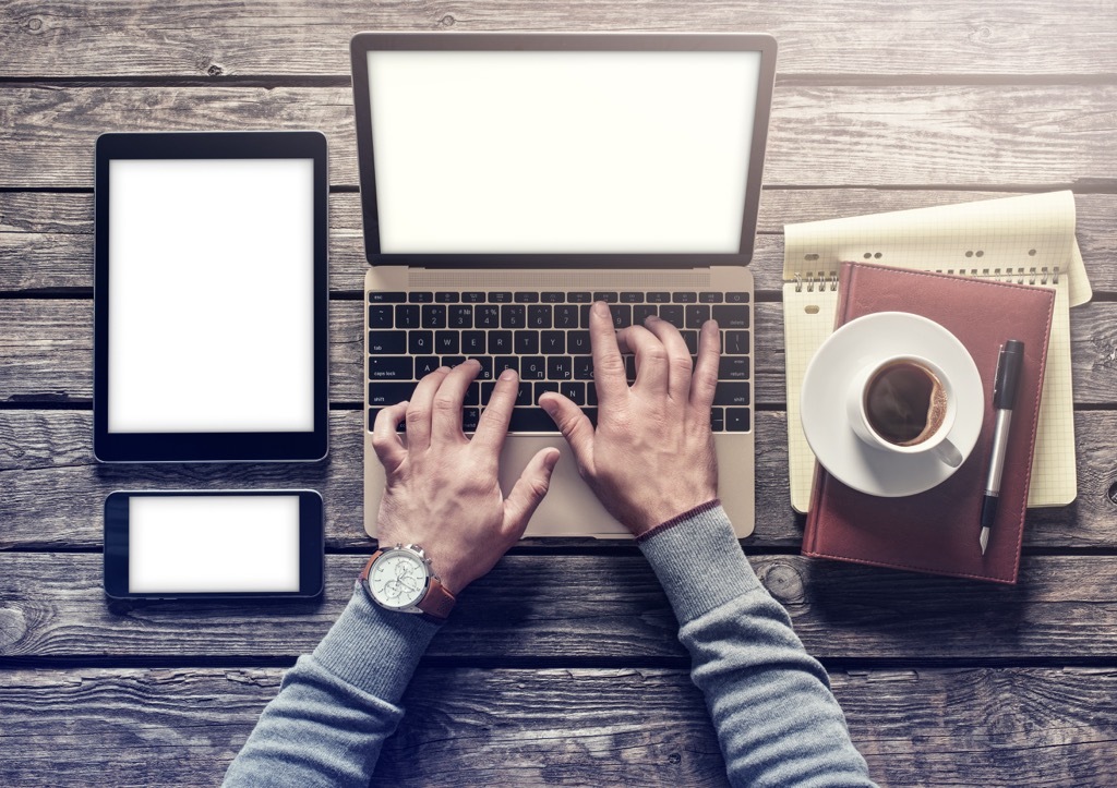 man typing on laptop