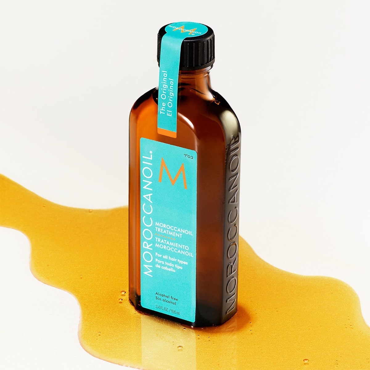 Moroccanoil bottle in pool of argan oil