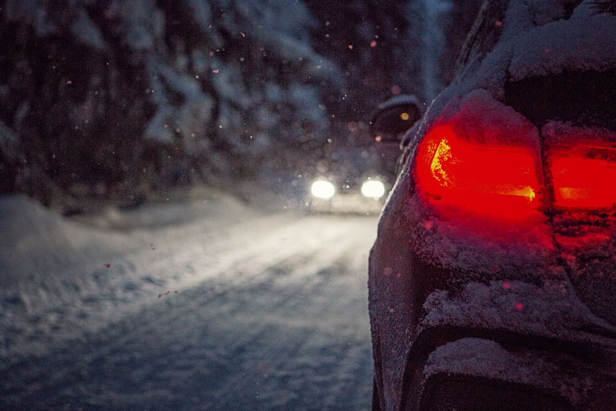 Driving in a snowy forest at night