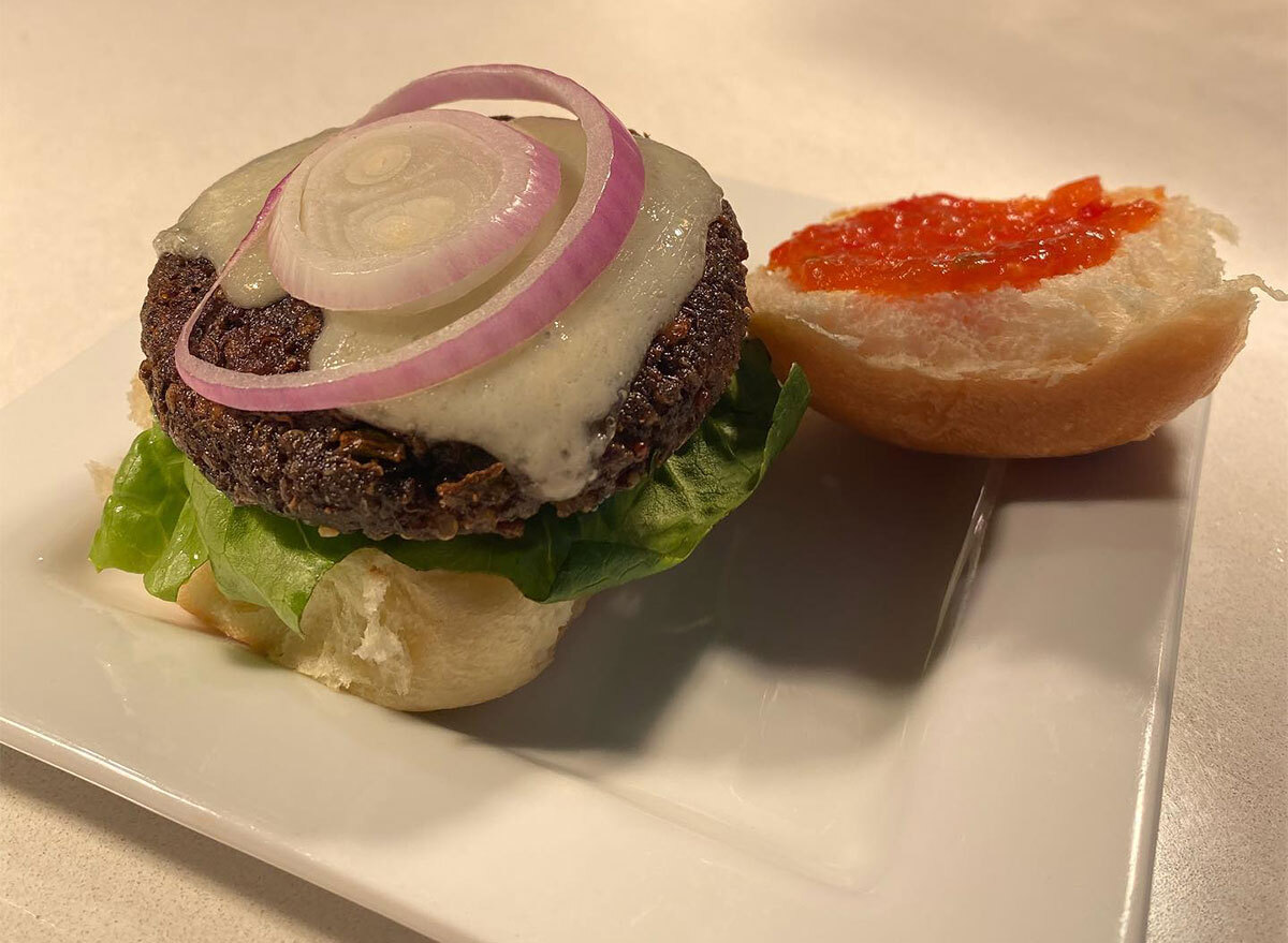 plated veggie burger topped with lettuce and onion