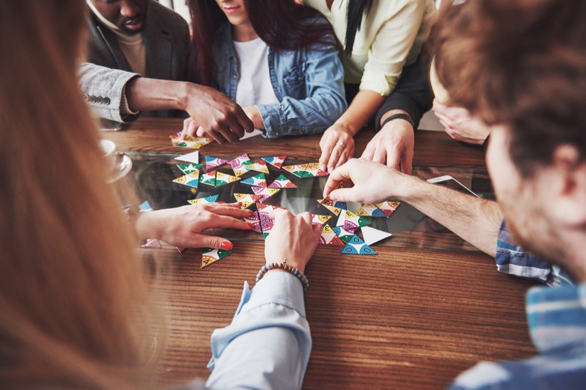 People having fun while playing board game