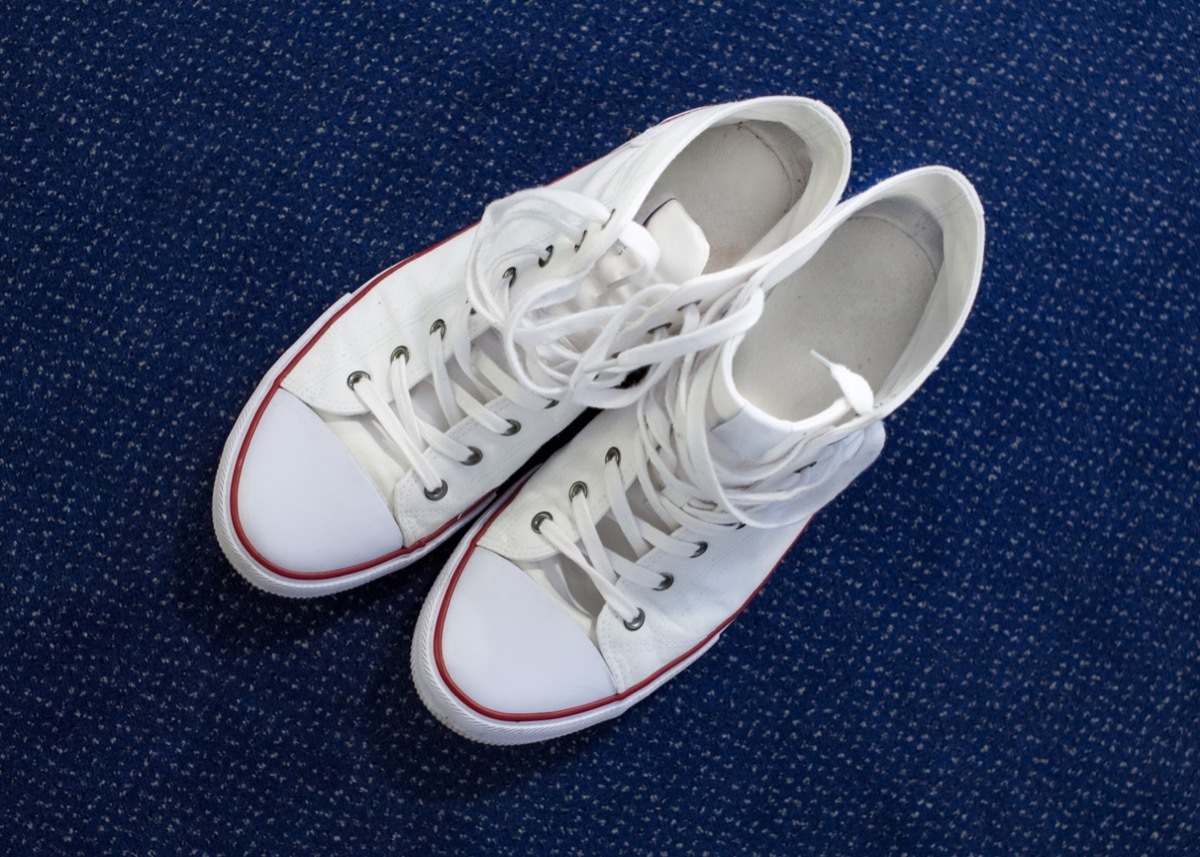 White Sneakers photographed from above on a blue carpet