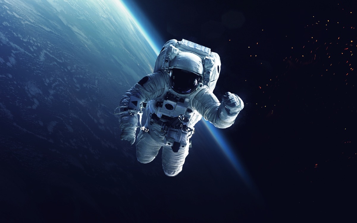 astronaut working in space with earth in the background