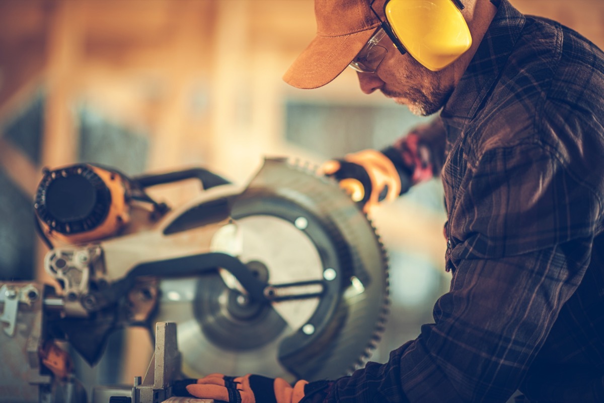 man using power saw