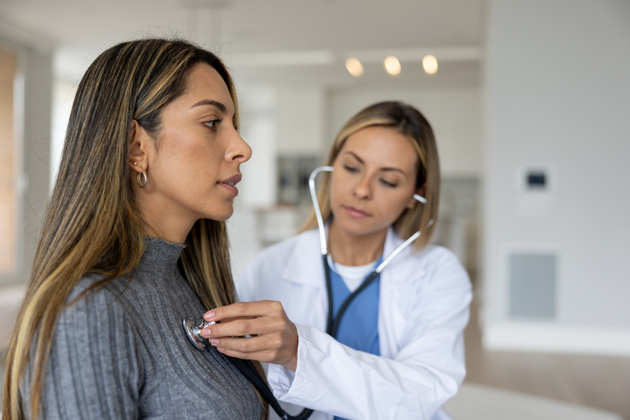 Doctor listening to patient's heart. 