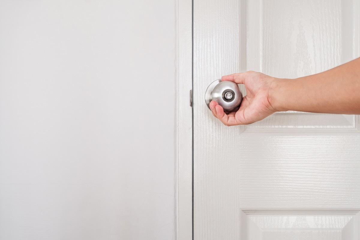 woman reaching for door handle