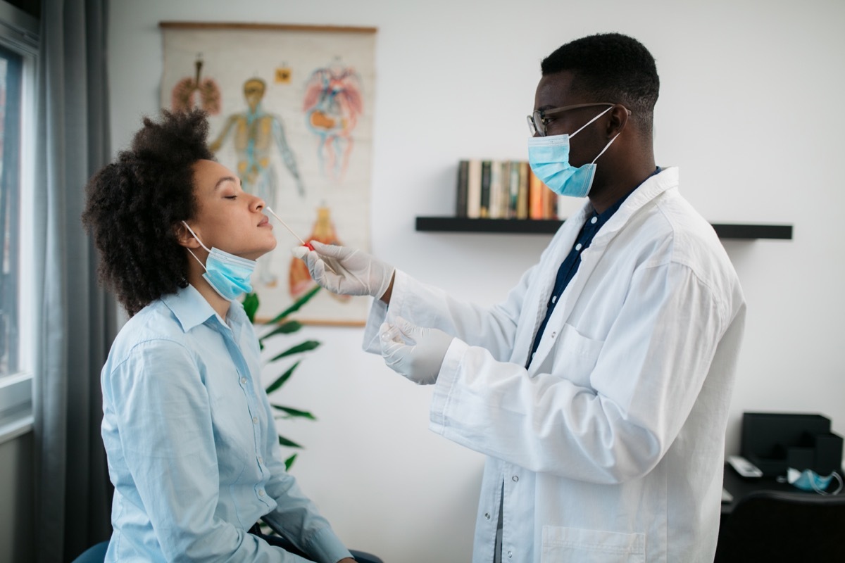 woman getting tested in a medical clinic for a corona virus, taking a nasal swab test