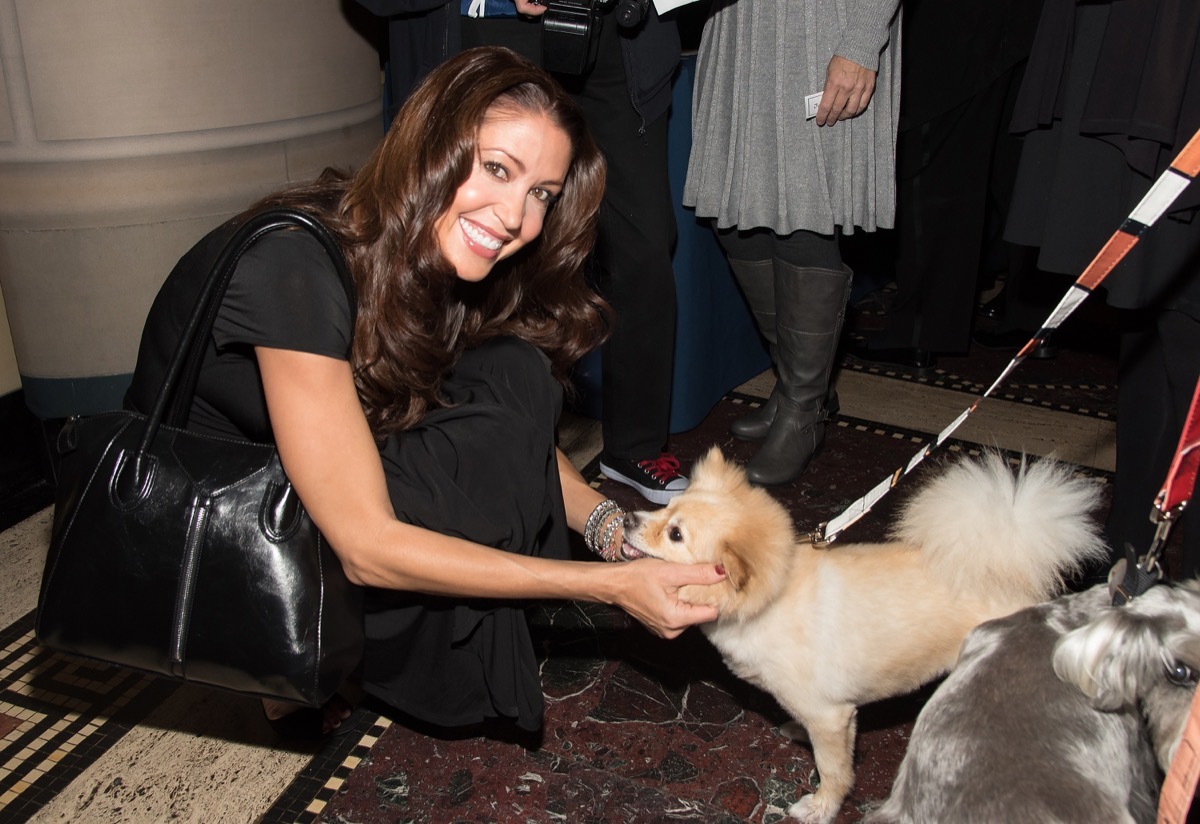 Shannon Elizabeth petting a dog