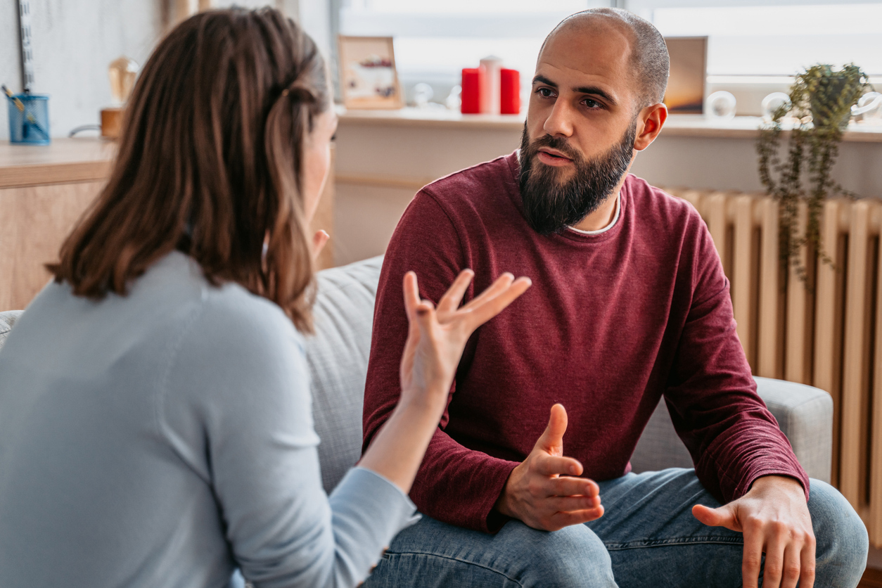 Young couple with relationship problems arguing at home.