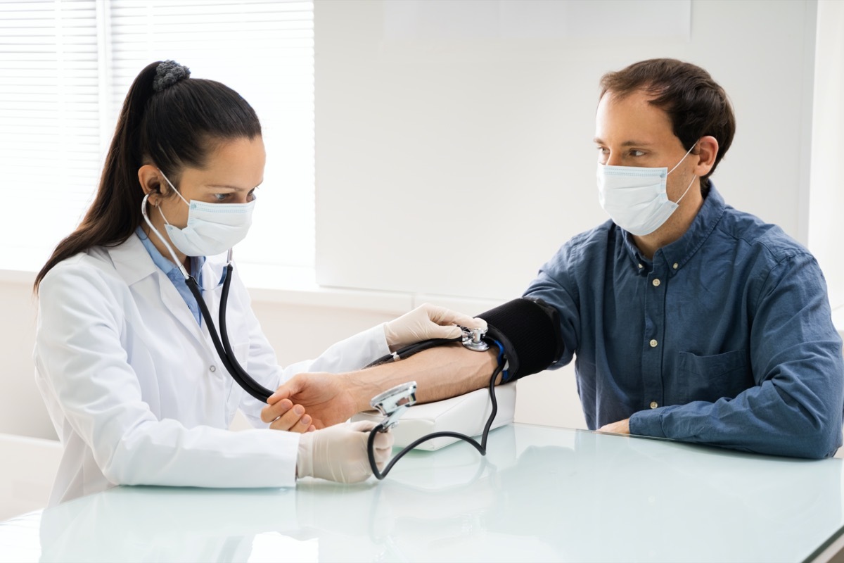 Doctor Checking High Blood Pressure In Face Mask