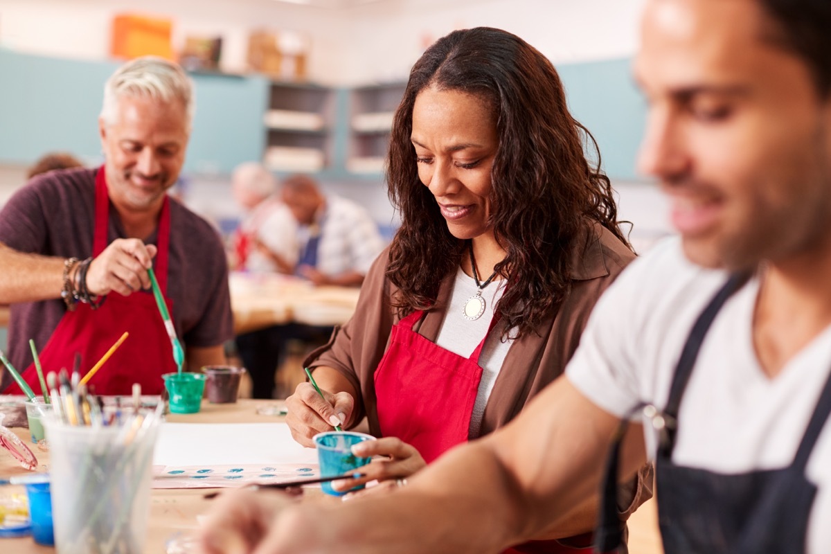 two men and one woman in painting class