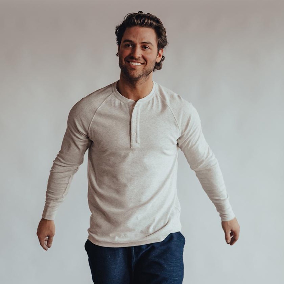 young man in cream colored henley