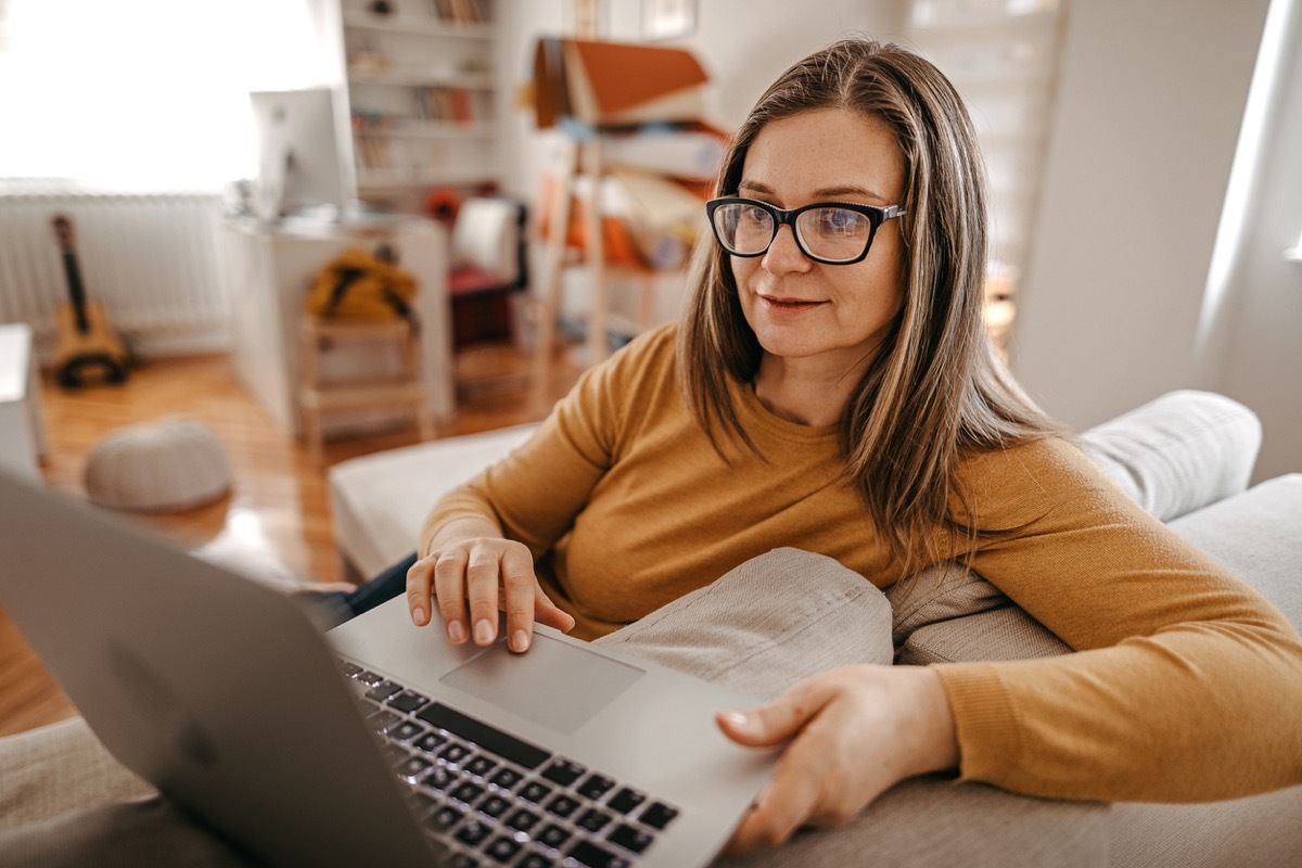 Mature woman having online consultation with psychotherapist at home on laptop