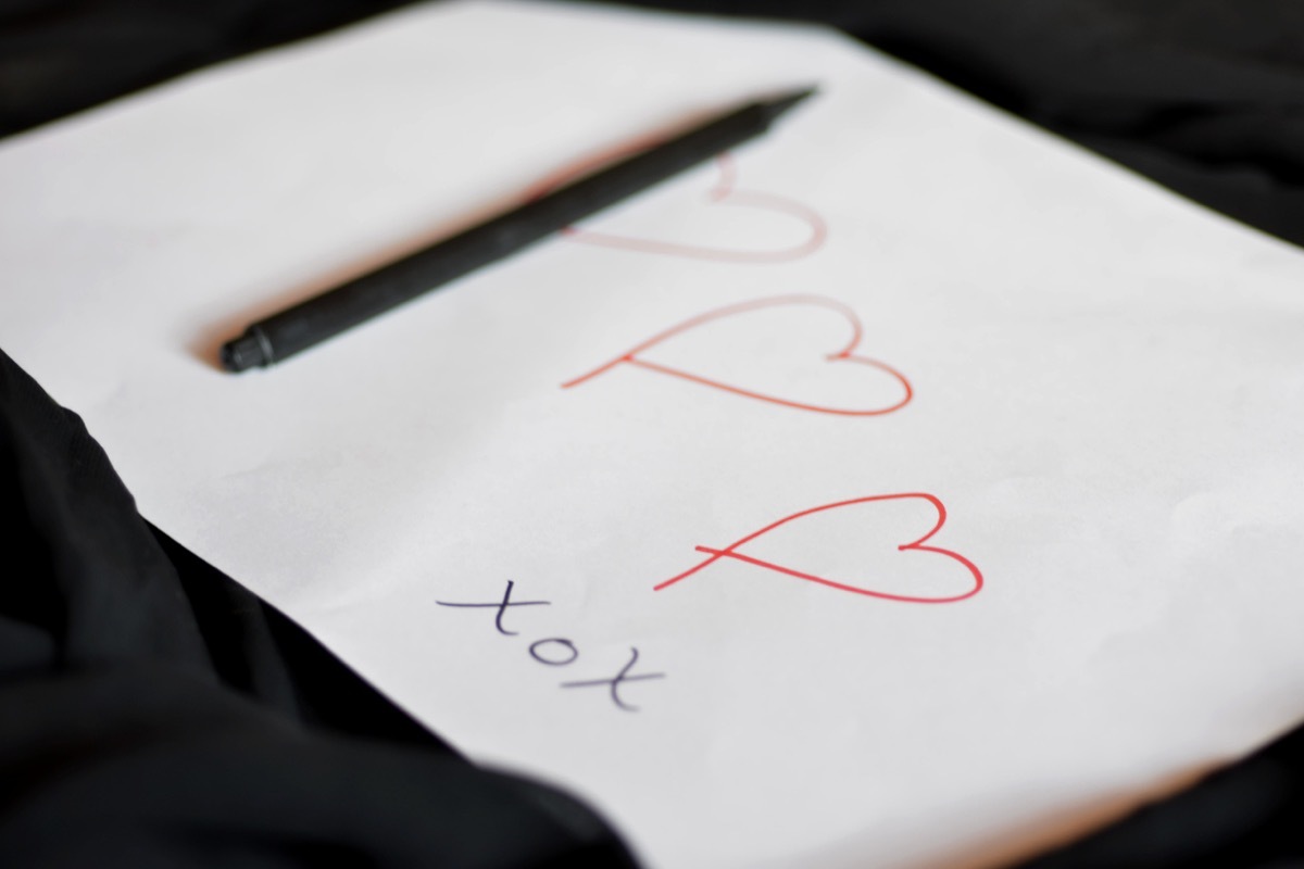 Love note handwritten heart shapes on white paper with pencil