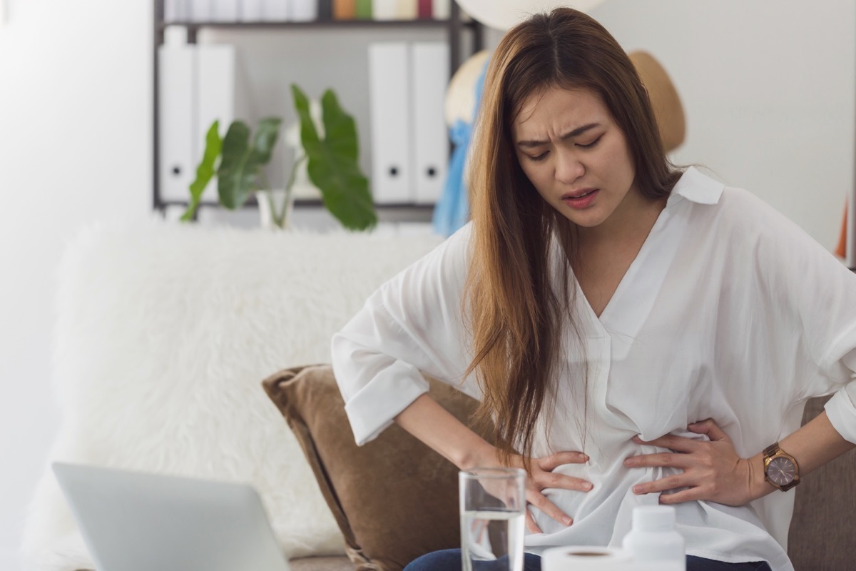 woman experiencing nausea and stomach pain