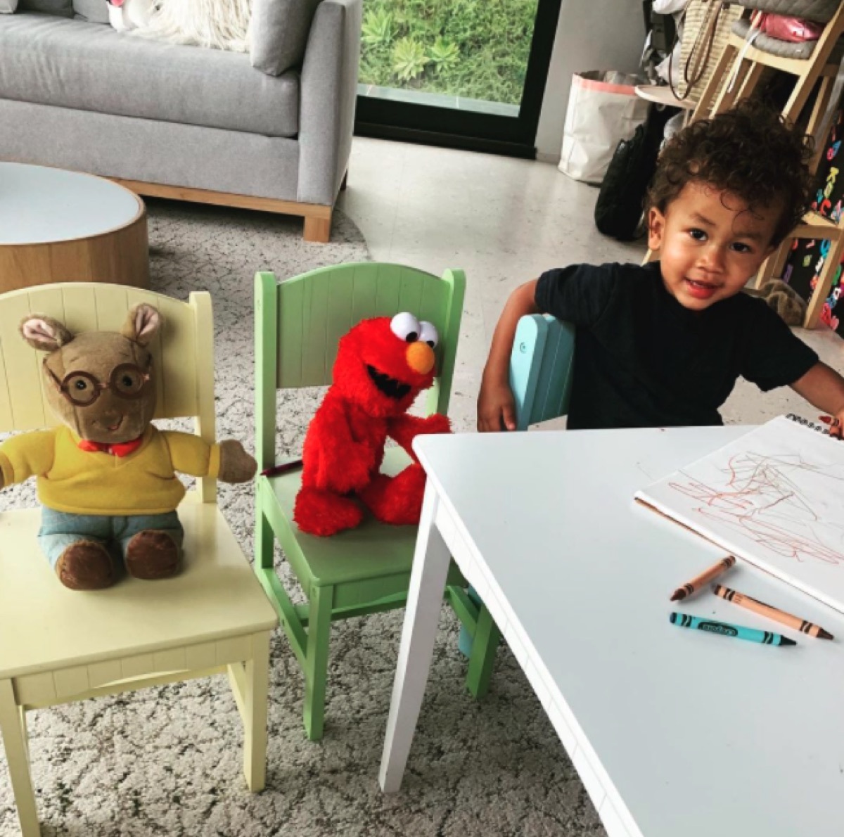 Miles Stephens with Elmo and Arthur toys