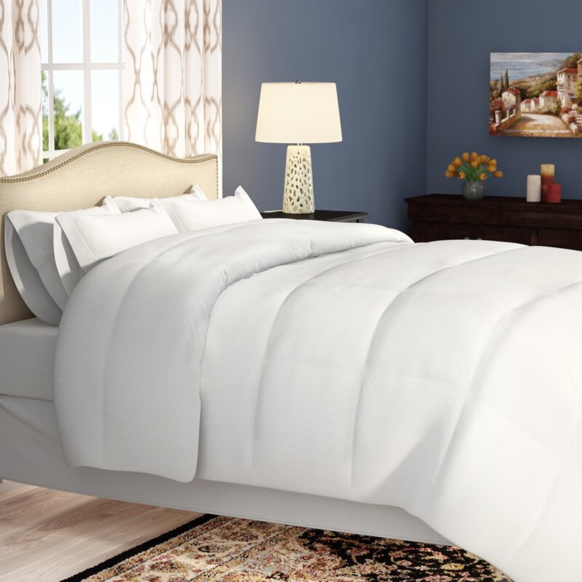 white comforter in blue bedroom