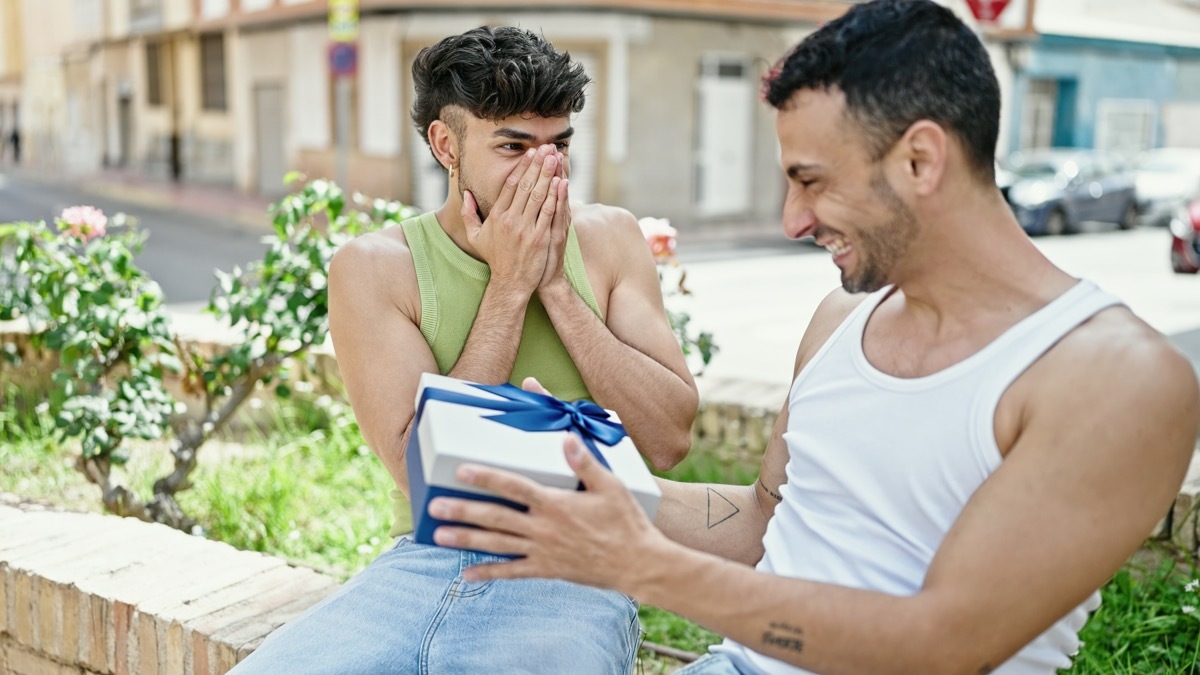 two men surprising each other with gifts