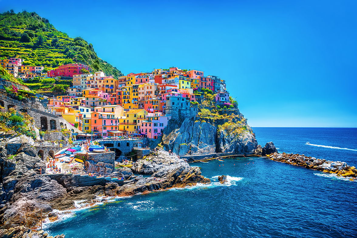 pastel colored buildings on a seaside cliff in italy