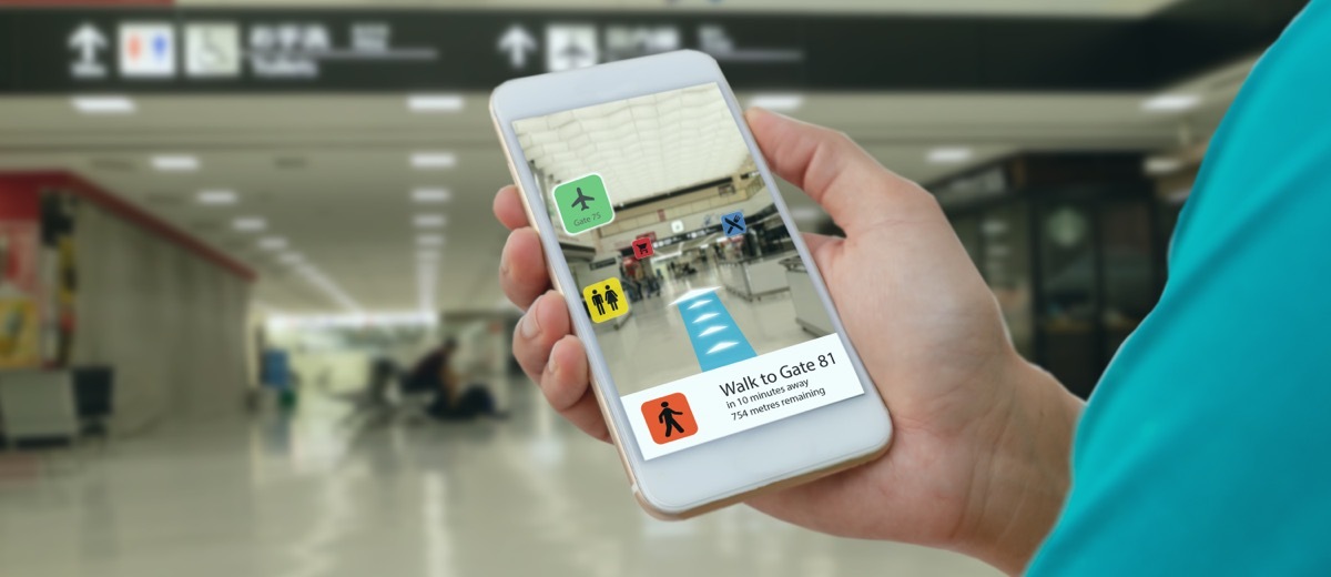 Person Holding Phone Open to Airport Terminals