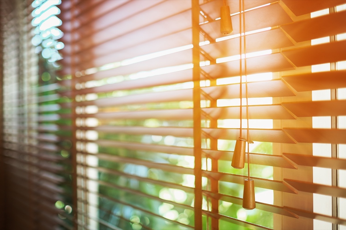 open wooden blinds letting light in