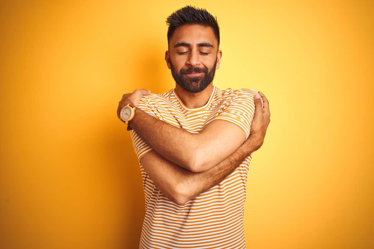 man giving himself a hug