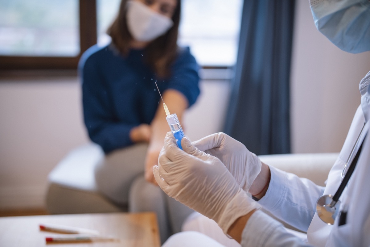 Doctor injecting vaccine to patient