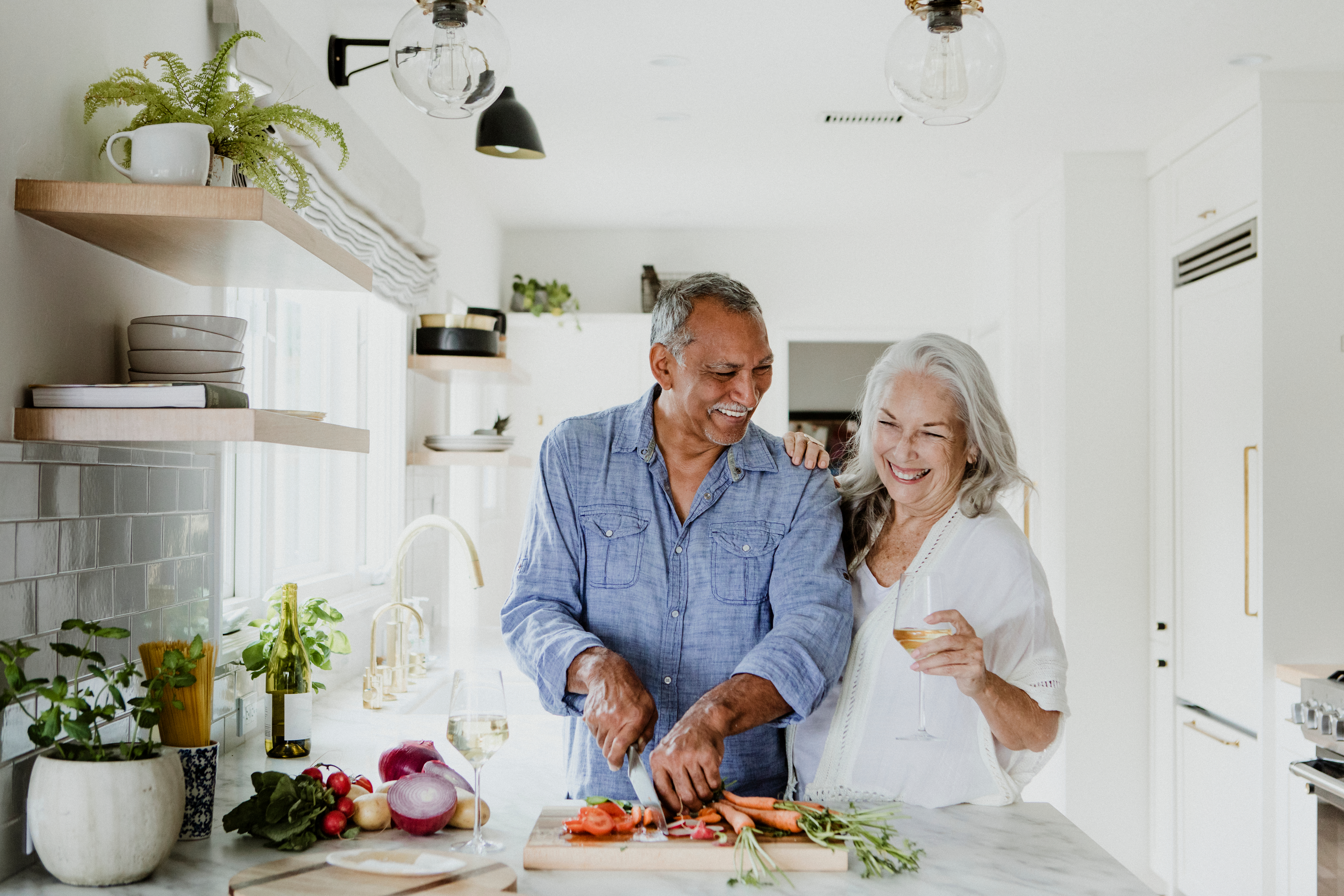 two seniors cooking together and enjoying their retirement