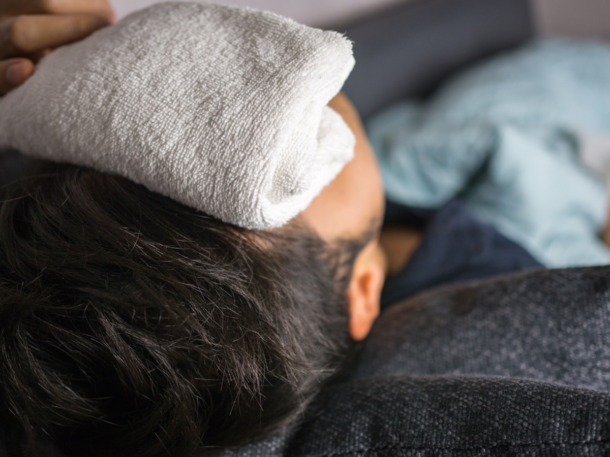 Towel on forehead, on man feels sick