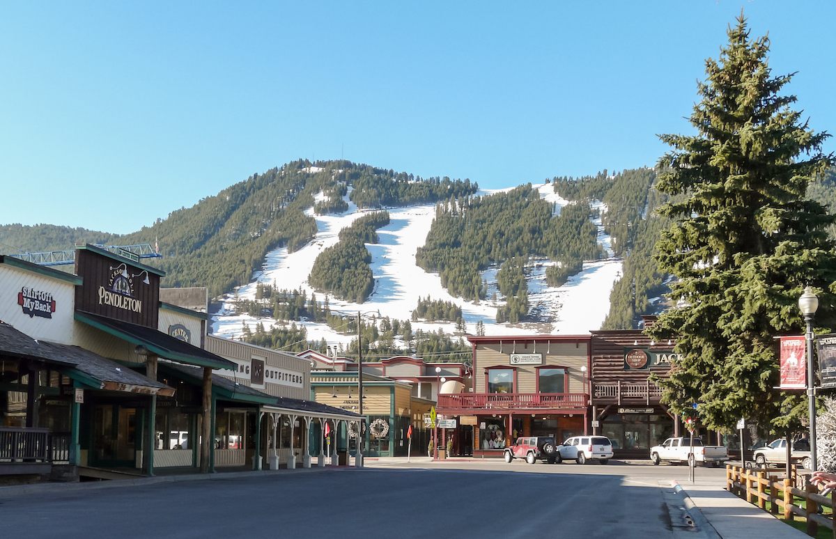 The old western buildings in downtown Jackson, Wyoming with the ski slopes in the background.