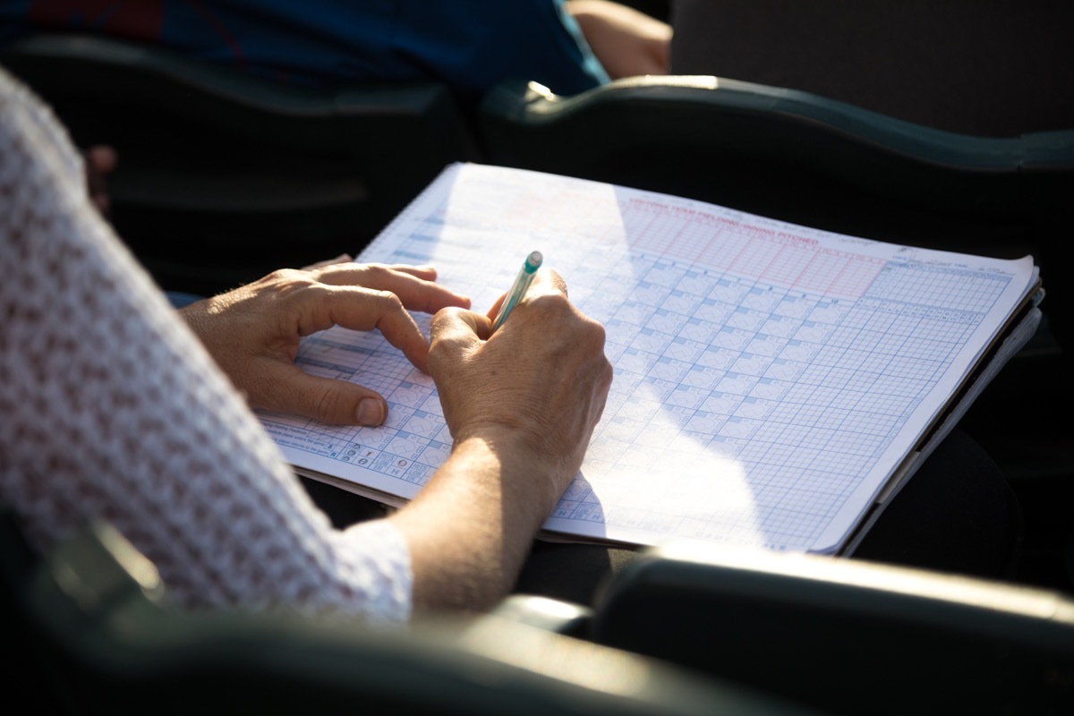 Woman updating a scorecard