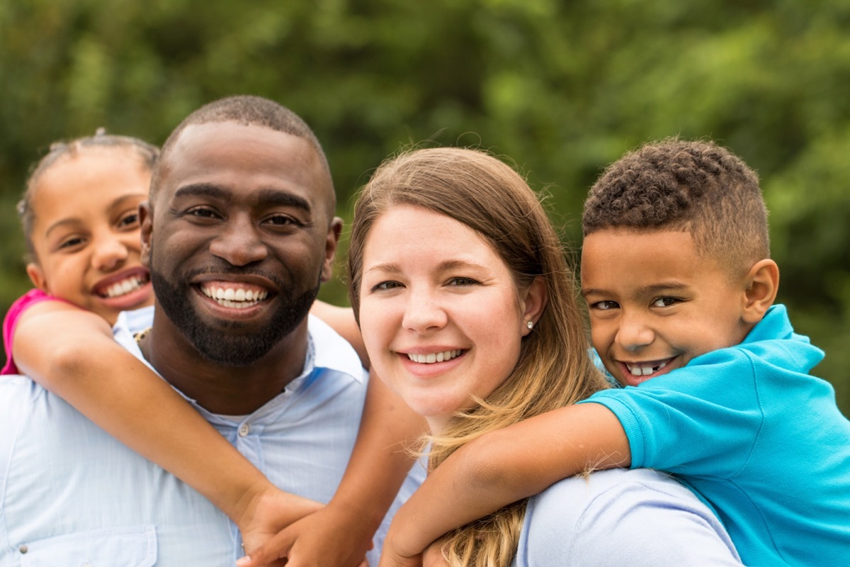 interracial couple with two children outdoors being a step-parent