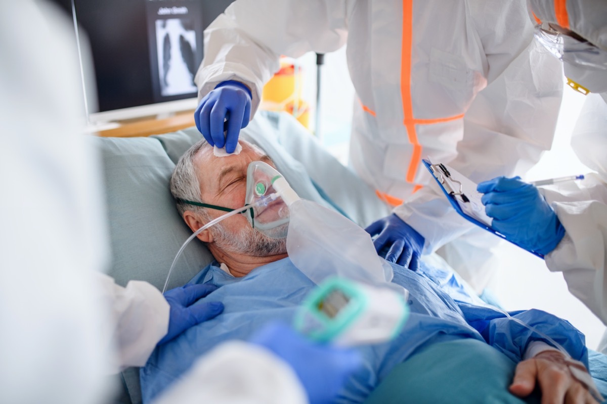 Infected patient in quarantine lying in bed in hospital.