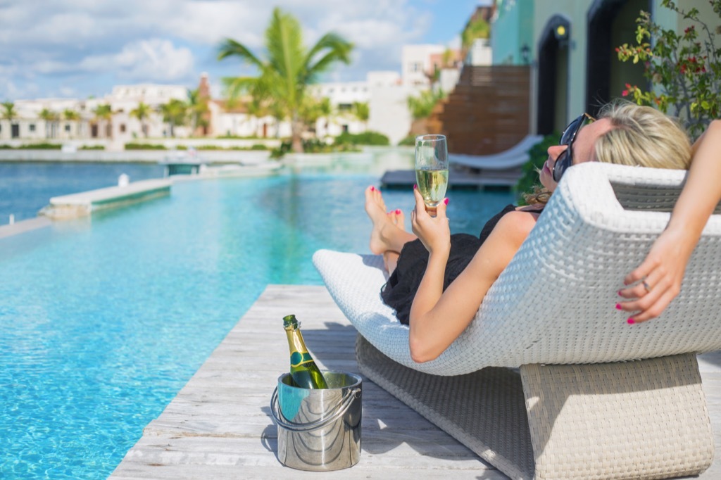 woman drinking by the pool