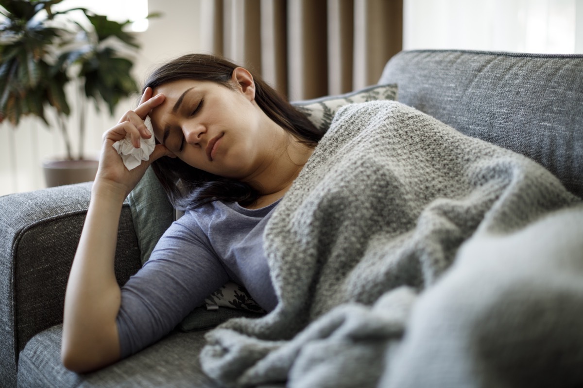 Sick woman lying in bed