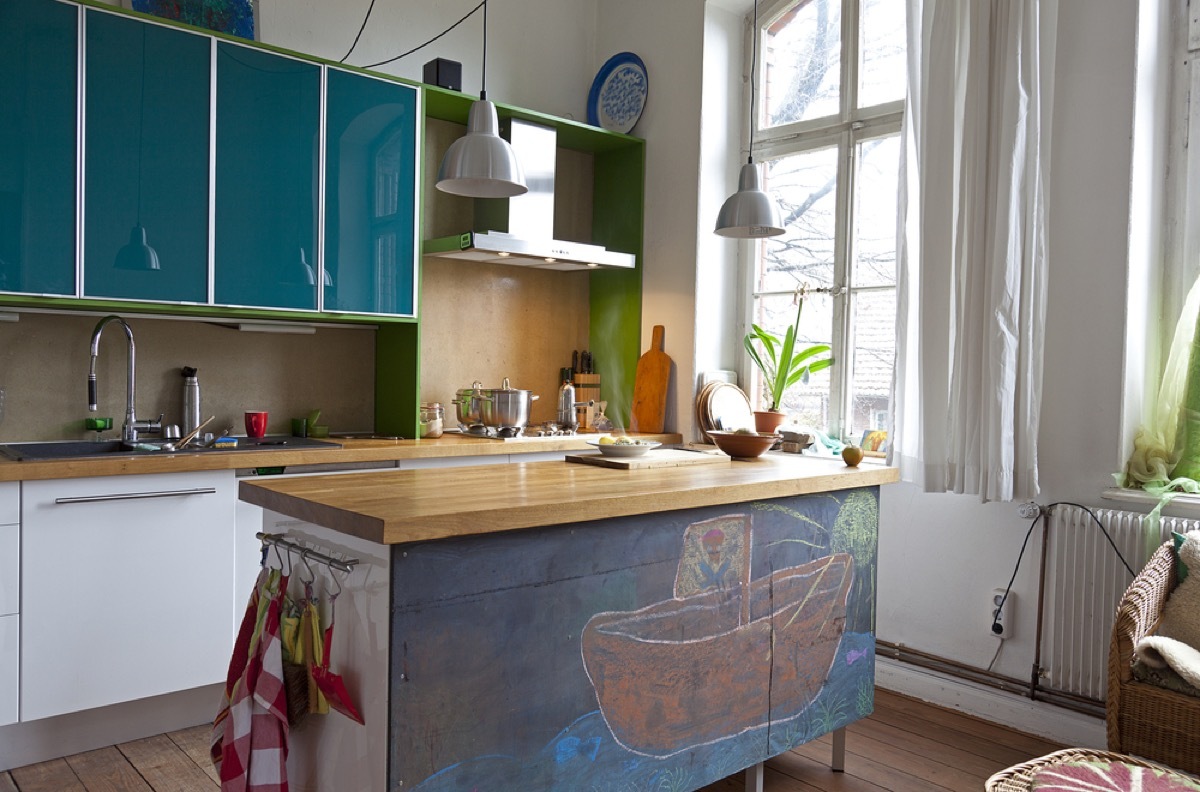 modern kitchen with chalk painted island and teal cabinets