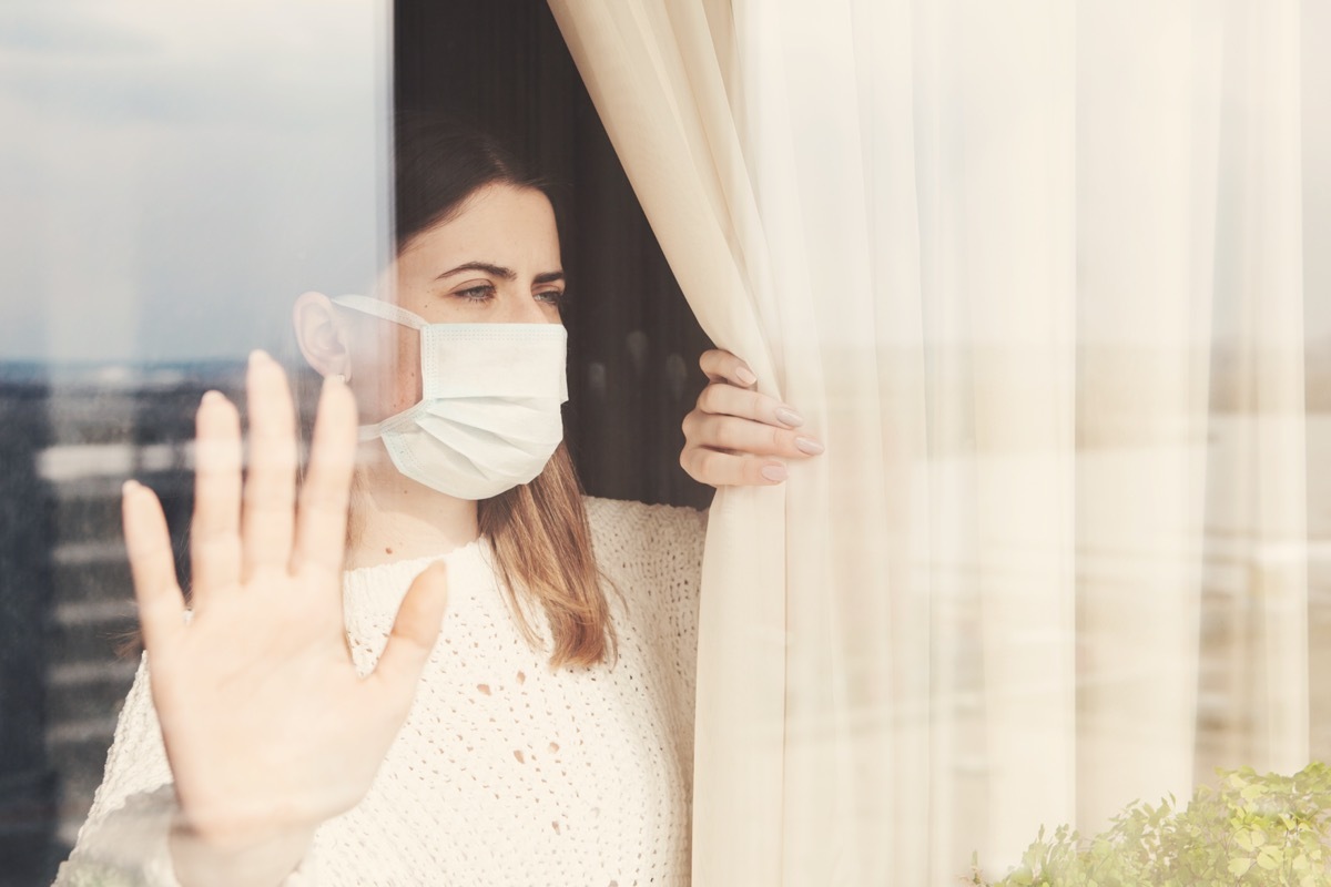 woman in medical mask stay isolation at home for self quarantine