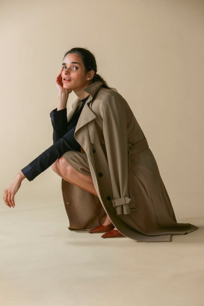 Woman with trench over her shoulders