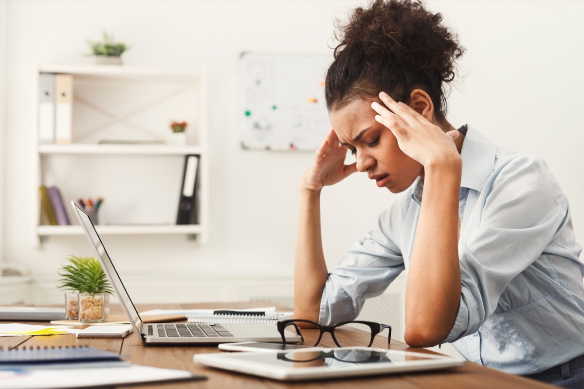 Woman with a headache while she is working