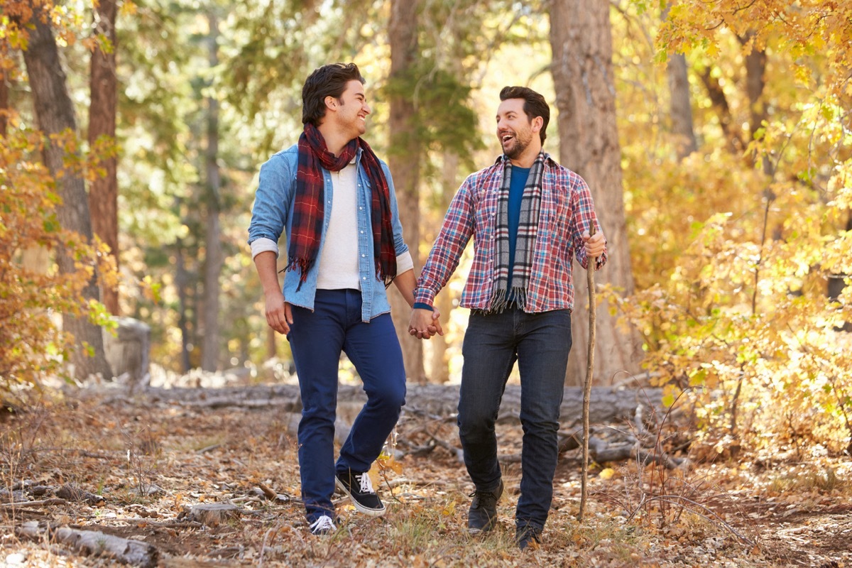 Gay Male Couple Walking and Hiking Through Fall Woodland Together