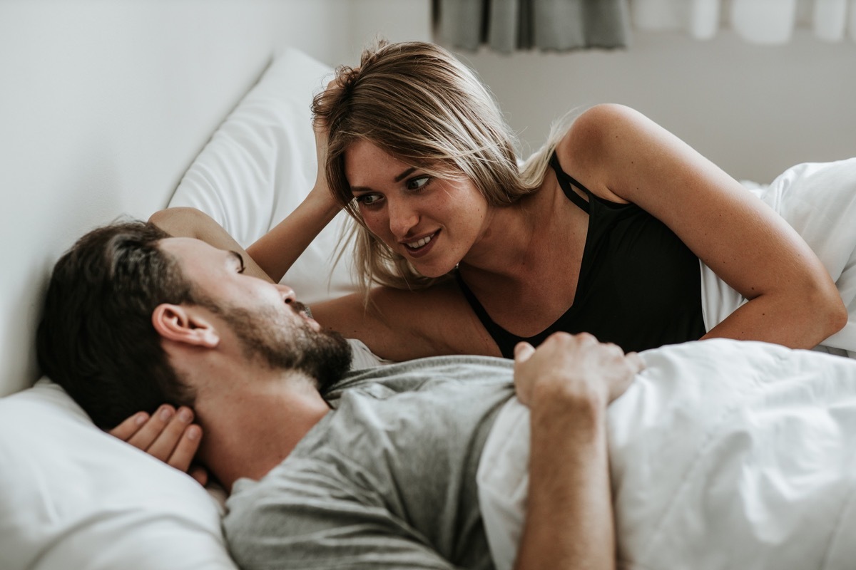 Romantic moment: Happy couple in love in the bed - Stock image