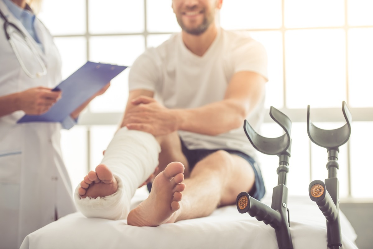 Man in the hospital with a cast because of a broken leg